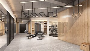 A modern gym with exercise equipment, wooden accents, and a minimalist design. - Stey Wangfujing (Beijing)