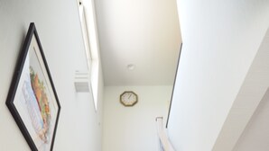 A staircase with wooden steps and a handrail, leading upwards. - Condominium Orchid House Nakijin (Nakijin)