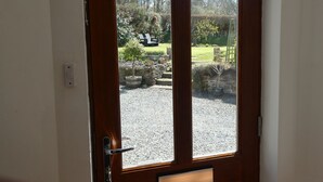 A wooden door with a glass panel, a metal handle, and a small mailbox below the glass. - Peaceful Rural Location Set Within 5 Acres Of Pasture and Woodland, pet friendly (Great Torrington)