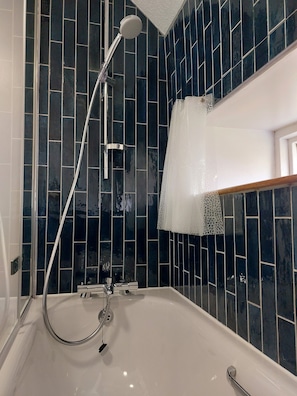 Combined shower/tub, hair dryer, towels, soap