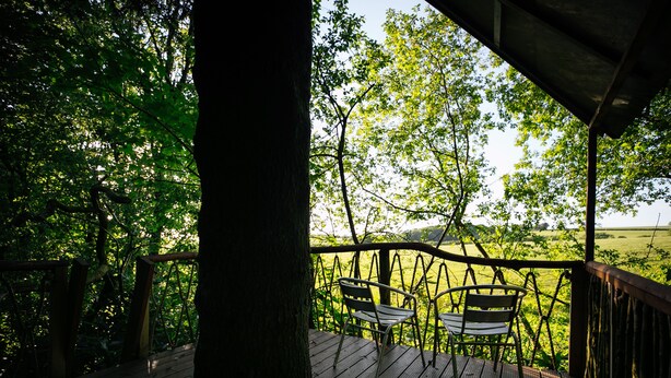 A wooden deck with two chairs overlooking a lush green landscape. - Peaceful Rural Location Set Within 5 Acres Of Pasture and Woodland, pet friendly (Great Torrington)