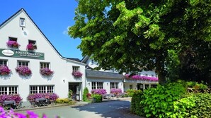 A white building with a sign reading "Haus Dumichetal Hotel-restaurant".