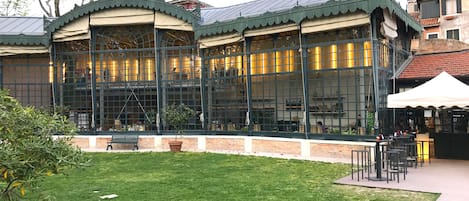 A building with large glass windows and a green roof.