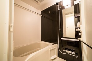 A bathroom with a bathtub, a shower, and a toilet. - Universal Haneda (Tokyo)