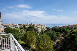 Un pueblo costero con edificios en una ladera con vistas al mar.