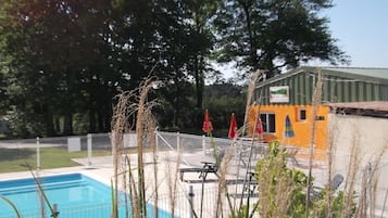 Seasonal outdoor pool, open 11 AM to 9 PM, pool umbrellas, pool loungers