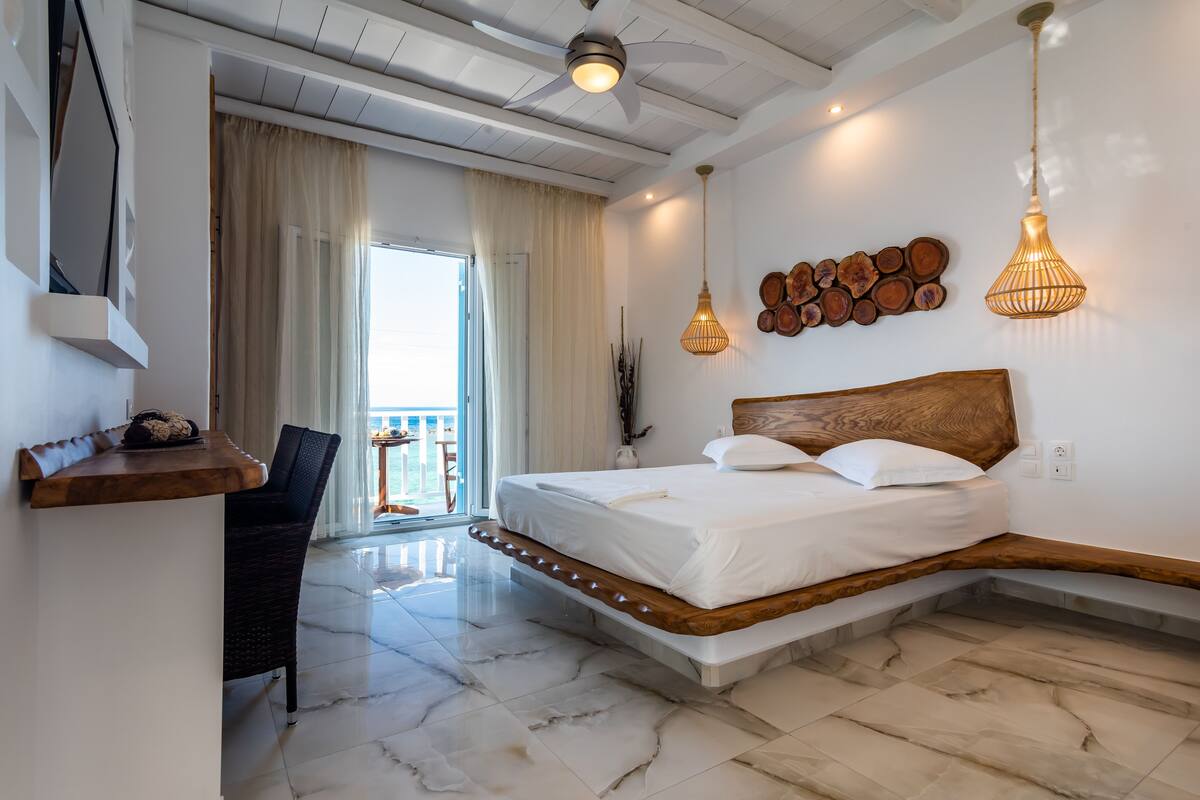 A modern bedroom with a bed, a desk, and a chair.