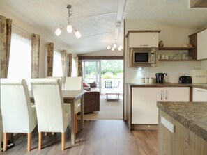 Mobile Home (Cedar Lake 37) | Private kitchen | Microwave, oven, stovetop, electric kettle - Caravan Hire at Southview Leisure Park (Skegness)