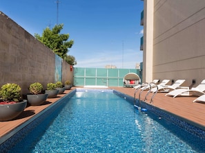 Outdoor pool, open 9:00 AM to 9:00 PM, sun loungers, lifeguards on site