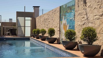 Outdoor pool, open 9:00 AM to 9:00 PM, pool loungers, lifeguards on site