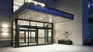 A hotel entrance with a glass door and a sign reading "Homewood Suites." - Homewood Suites by Hilton Providence Downtown (Providence)