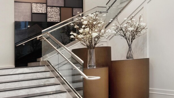 A modern staircase with glass railings and a geometric wall design. - Homewood Suites by Hilton Providence Downtown (Providence)