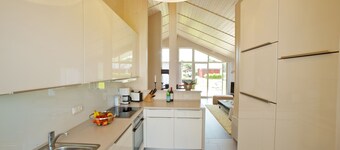  Exclusive wooden house with high sense right on the North Sea dike