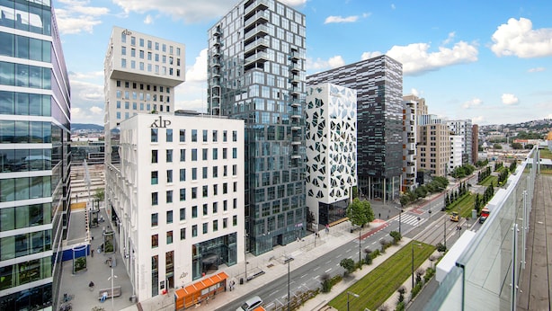 A modern urban area with high-rise buildings, a pedestrian walkway, and a clear sky. - Clarion Hotel Oslo (Oslo)