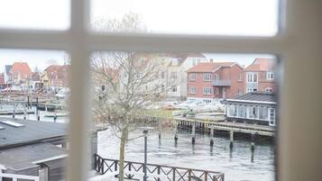 A view of a riverside area with buildings and a dock.