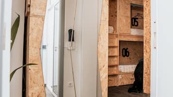 A room with a wooden wall panel, a white door, and a mirrored closet door.