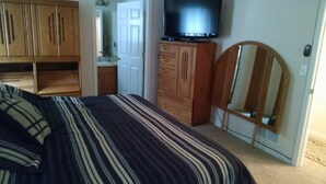 A bedroom with a bed, wooden wardrobe, a television, and a mirror. - Cleveland Airport
Bundle yourselves together (Brook Park)