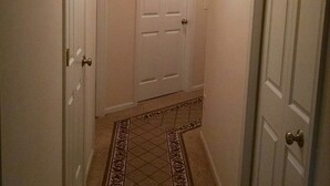 A narrow hallway with patterned carpet, white doors, and a ceiling light. - Cleveland Airport
Bundle yourselves together (Brook Park)