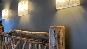 A rustic wooden headboard with a natural finish and a simple, straight design. - Romantic Retreat for Two: Make A Montana Memory! (Livingston)