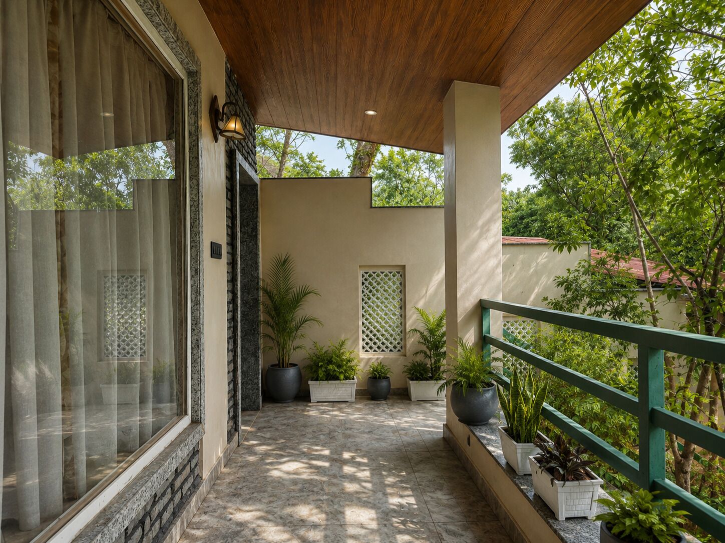 Un balcon extérieur abrité, doté d’un plafond en bois, de plantes en pot et offrant une vue sur la verdure.