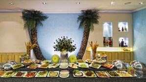A buffet setup with various dishes and a decorative centerpiece. - The Piccadily Lucknow (Lucknow)