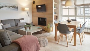 A modern living room with a sofa, coffee table, and dining area. - Val de Ruda Luxe 60 by FeelFree Rentals (Baqueira)