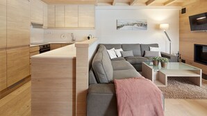 A modern living space with a sofa, a coffee table, and a TV. - Val de Ruda Luxe 60 by FeelFree Rentals (Baqueira)