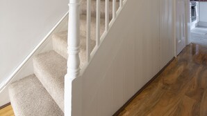 A staircase with white balusters and carpeted steps leading to a landing. - Fortified Home - Near Rochester Castle (Rochester)