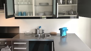 A modern kitchen with a built-in oven, a sink, and a countertop. - Gauk Apartments Sentrum 4 (Sandnes)