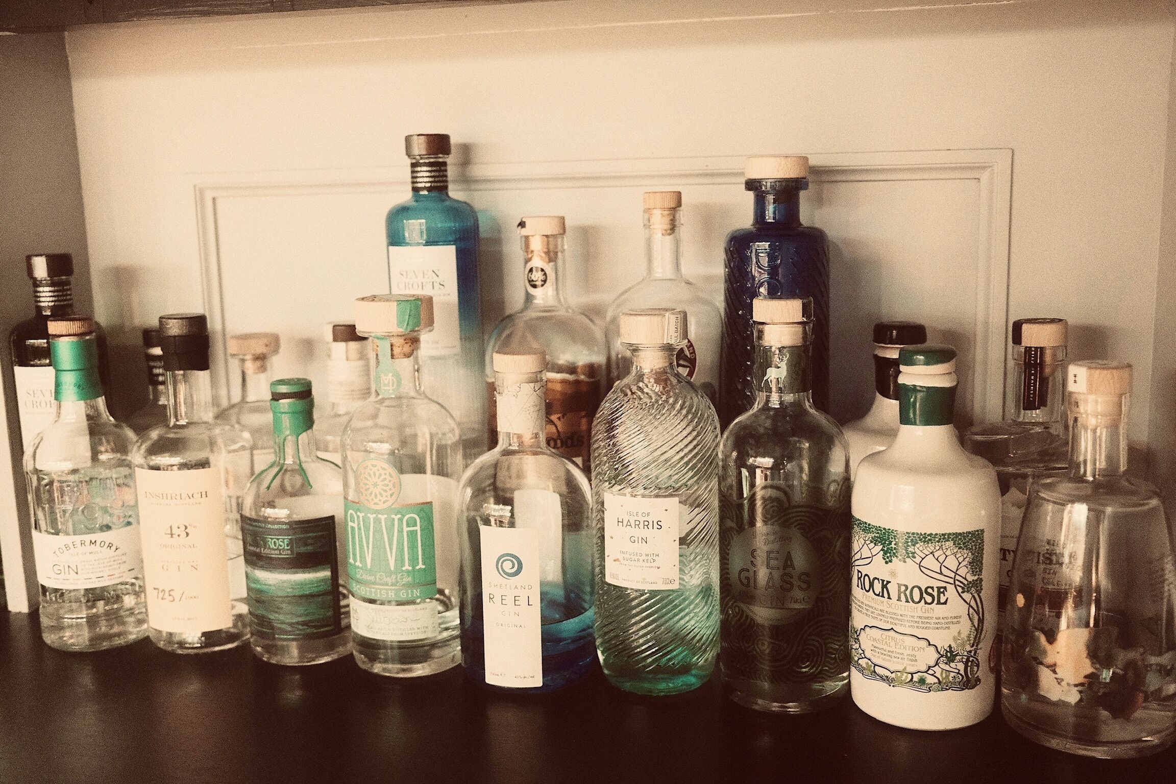 A collection of liquor bottles on a shelf.
