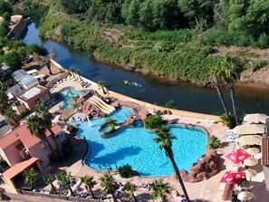 A resort with a large swimming pool, a water slide, and a river nearby. - Camping Tikayan La Vallée du Paradis (Saint-Raphael)