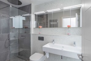 A modern bathroom with a glass shower enclosure, a white sink, and two mirrors above the sink. - The Van Morrison Suite - hiphipstay (Dublin)