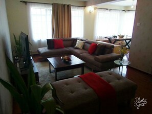 Exclusive Apartment | Living room | 50-inch flat-screen TV with premium channels, TV