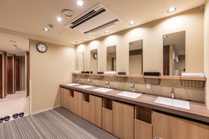 A modern bathroom with three sinks, wooden cabinets, and mirrors. - Tabist CapsuleHotel APODS Himeji Station (Himeji)