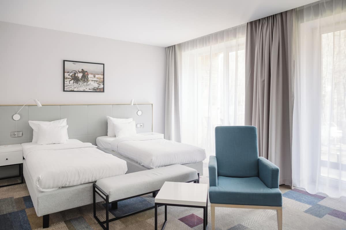Premium bedding, desk, laptop workspace, blackout drapes