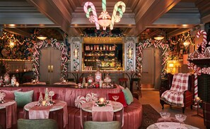 A bar area with a variety of bottles and a selection of desserts on display. - Woodlark Hotel Portland, a Tribute Portfolio Hotel (Portland)
