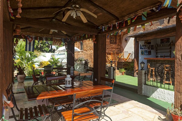 Relax on the patio surrounded by lush greenery and enjoy the serene views of the surrounding landscape.