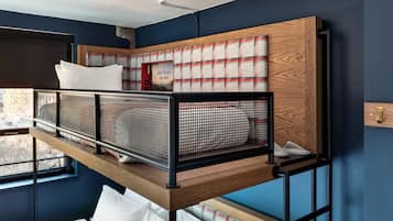 A bunk bed with a headboard that has a plaid pattern and a sign that says "Love to love you baby."