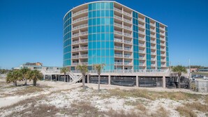 A multi-story hotel with a curved facade, balconies, and a covered walkway. - Sea Breeze-Sea Breeze 607 (Biloxi)