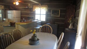 Cozy kitchen with a central island, sink, and dining table for two.