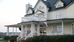 A large, two-story house with a wrap-around porch, multiple windows, and a chimney. - Lillian Farms Bed & Breakfast (Washington)