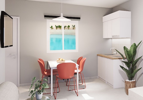 A modern kitchen with a dining area, white cabinetry, and a window with a view of a pool. - Melitti Lucent (Rethymno)
