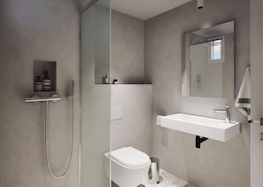 A modern bathroom with a glass-enclosed shower, a white sink, and a toilet. - Melitti Lucent (Rethymno)