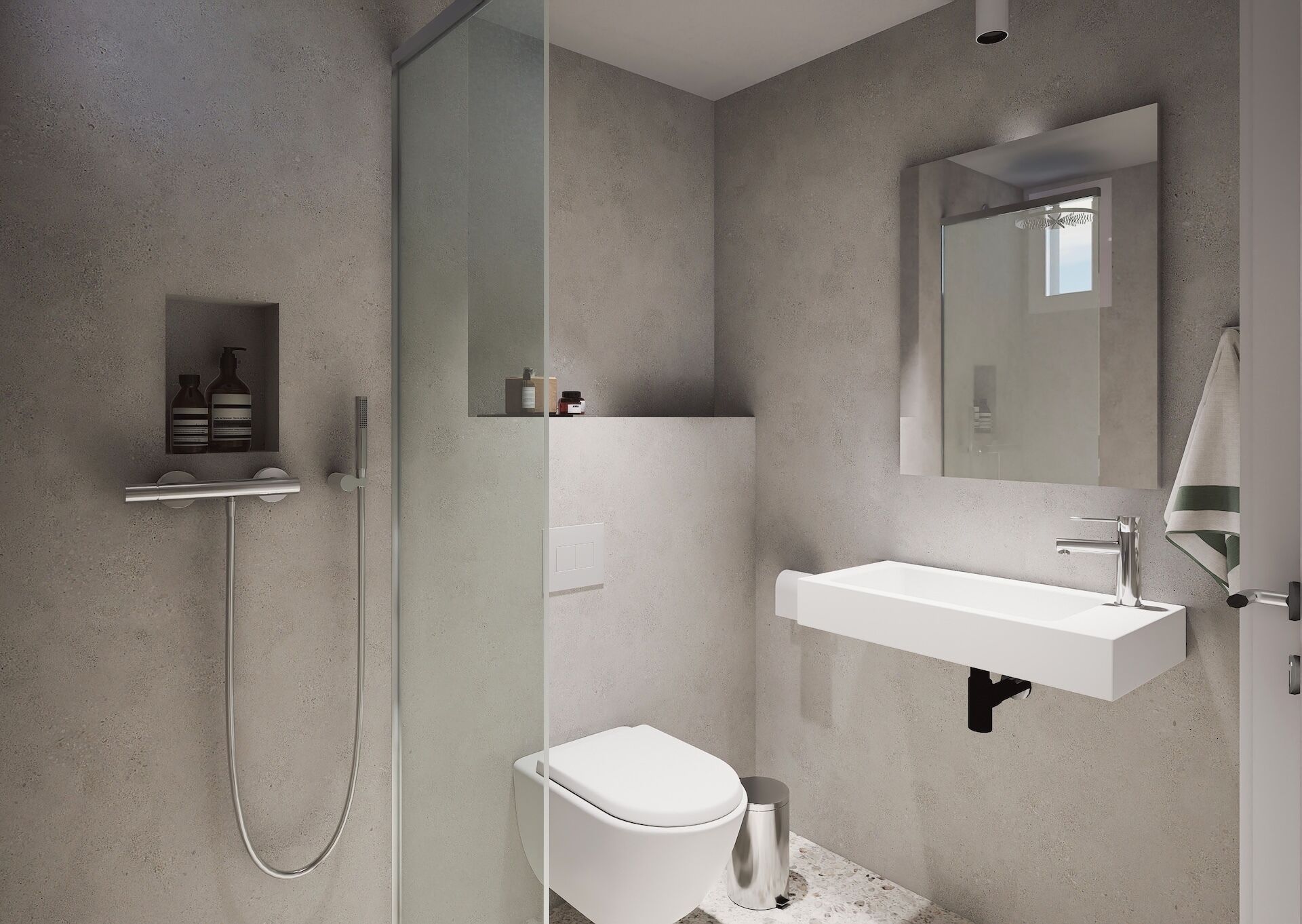 Ein modernes Badezimmer mit einer begehbaren Glasdusche, einem weißen Waschbecken und einer Toilette.