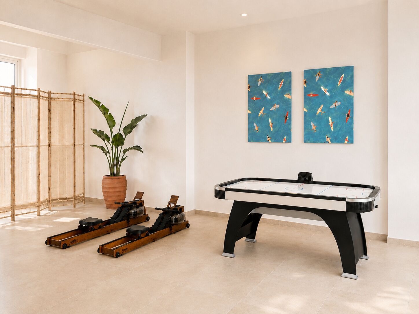 A pool table in a room with a bamboo screen, a potted plant, and two wall-mounted artworks.
