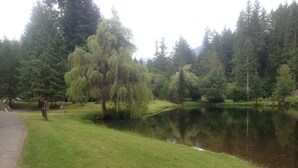 A serene park with a pond, ducks on the grass, and trees in the background. - 2-Story Chalet, clean, 3Br / 2Ba in Snowline, best rates, WiFi and Hot Tub (Glacier)