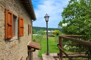 A stone building with wooden shutters, a metal lamp post, and a wooden fence. - Stunning private villa for 20 guests with private pool, WIFI, TV, terrace and pets allowed (Arezzo)