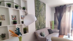 A living room with a sofa, a coffee table, and a wall-mounted shelf with plants. - Quiet apartment near the beach VV-35-3-0002306 (Tías)