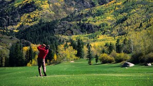 A person playing golf on a green field with a mountainous backdrop. - Walk to Vail Village Restaurants,  Shops & Lifts - Epic Views, Top Rated Condo! (Vail)