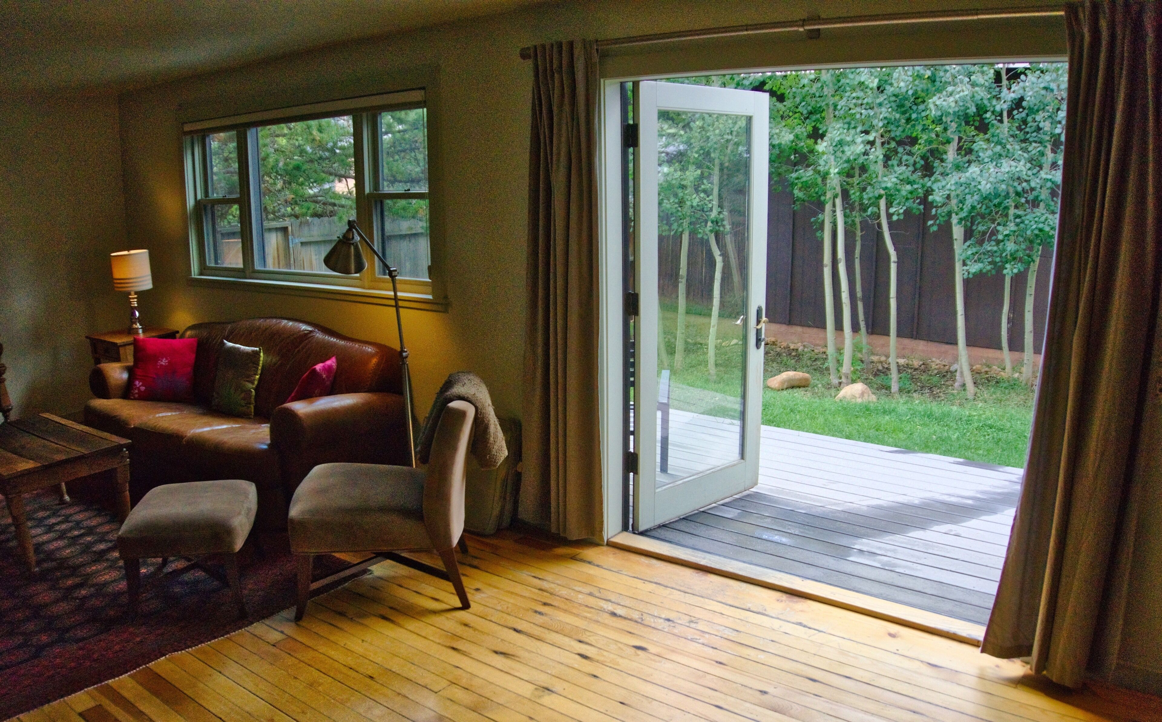 Living area with french doors to deck and backyard with grill and firepit